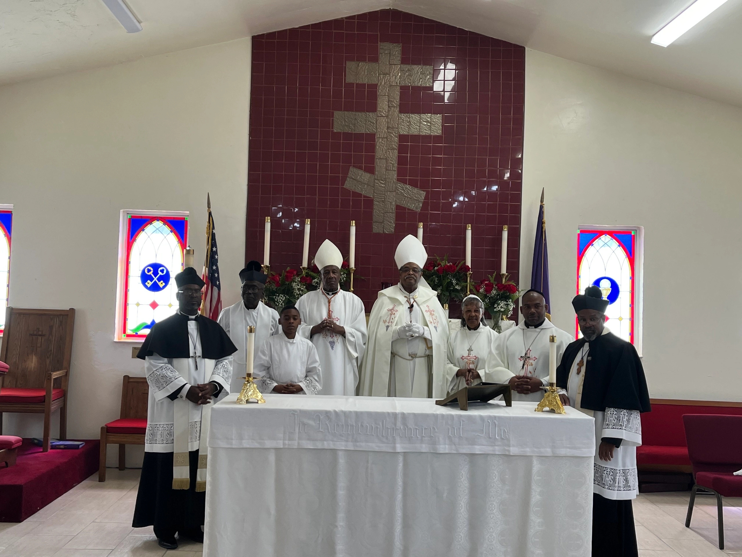 The clergy of the Mother Church at the altar, with Archbishop George Walter Sands at center.